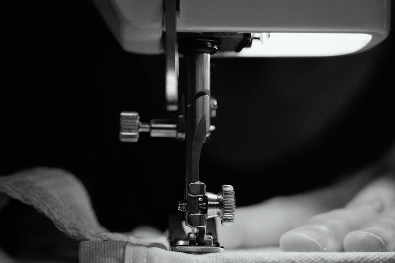 Sewing machine crafting an Esinama garment, representing our made to order approach and commitment to thoughtful, sustainable craftsmanship.