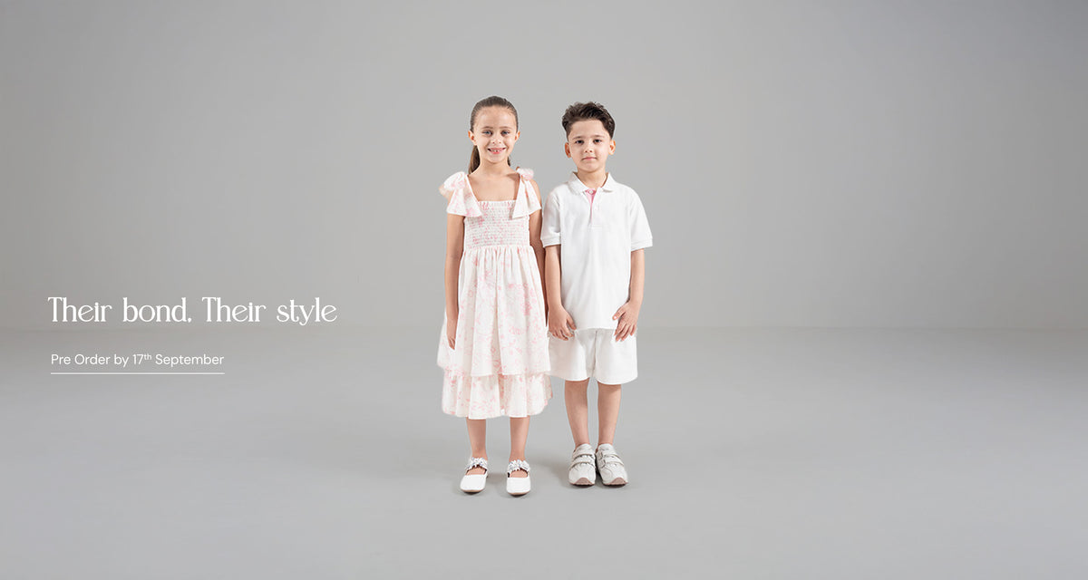 Two children in matching white outfits 